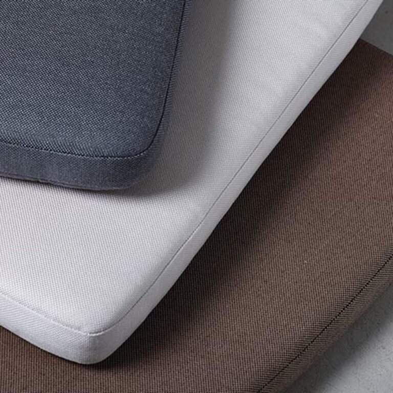 Colorful fabric swatches in various textures, including orange, gray, red, and patterned designs.