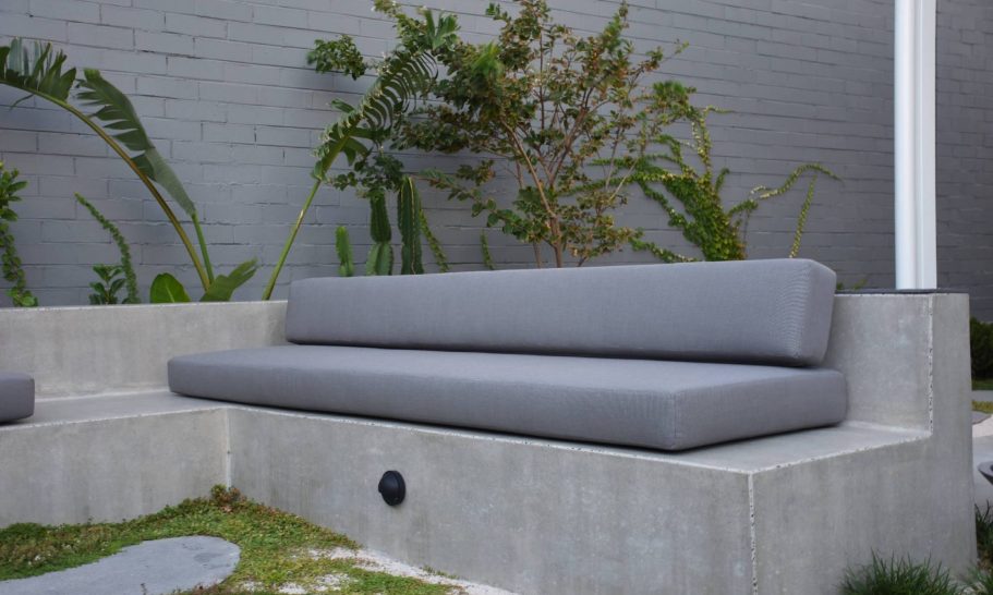 Bench seating with a navy blue background and a red floral pattern.